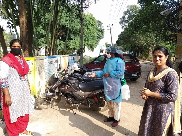Woman sanitizing a parking lot in Bangalore