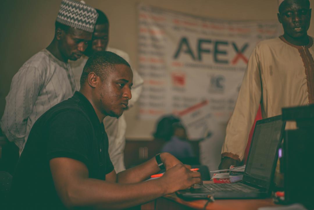 an African man using on a laptop