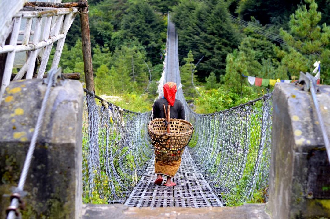 a woman crossing a bridge