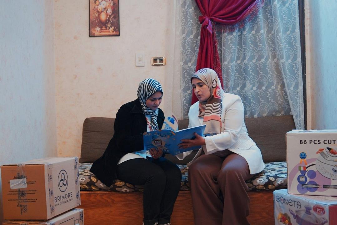 two Egyptian women studying sales documents