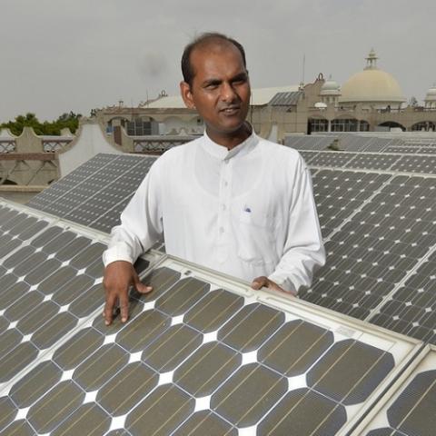 Indian man and solar panels