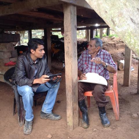 young man interviewing farmer