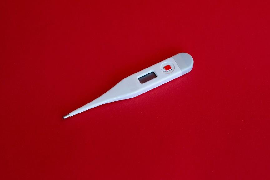 white thermometer on red background