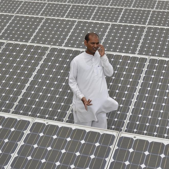 Arab man surrounded by solar panels