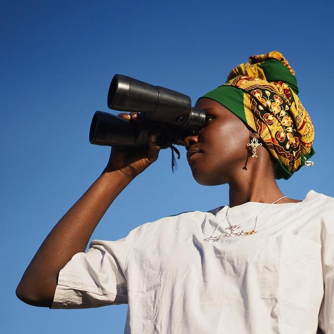 African woman using binoculars