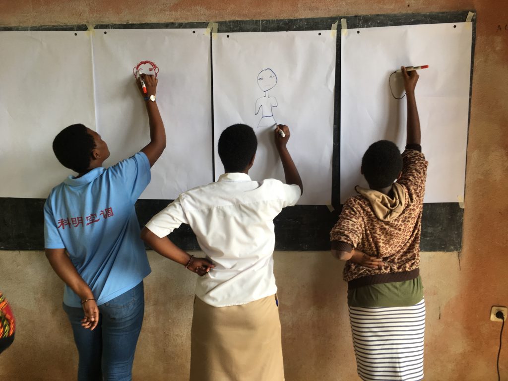 Girls drawing ‘a girl just like me’ in Kigali, Rwanda